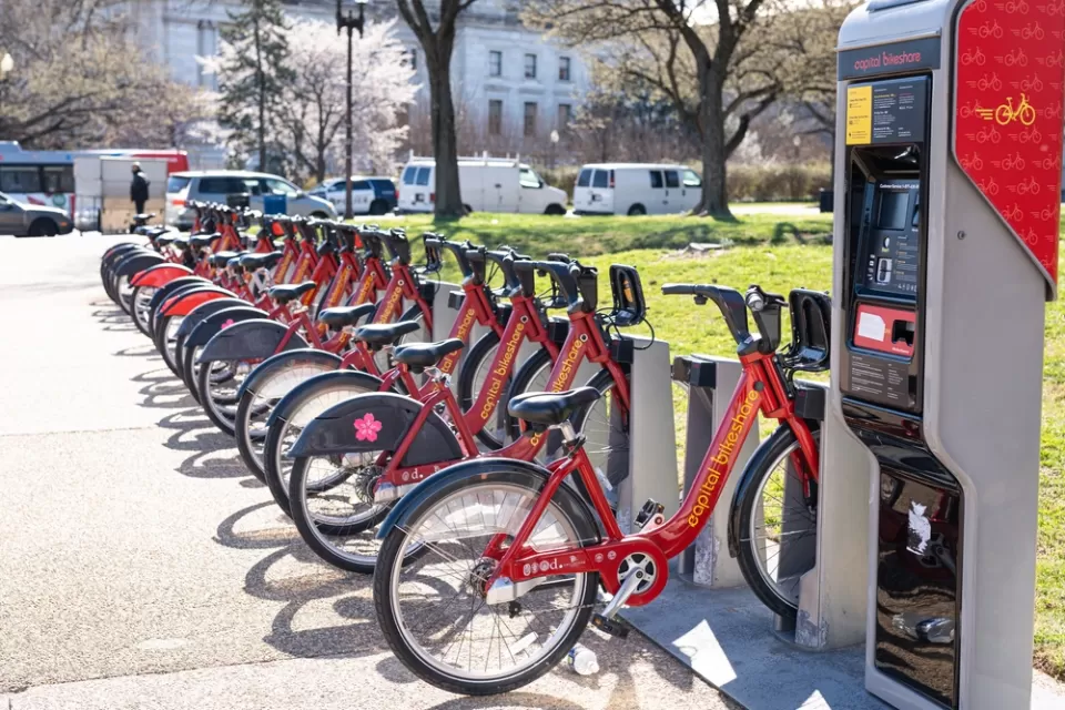Station with rown of red Capital Bikeshare parked bikes on Washington, D.C. sidewalk